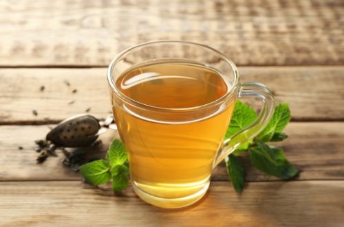 A clear glass mug of lemon balm lavender tea.